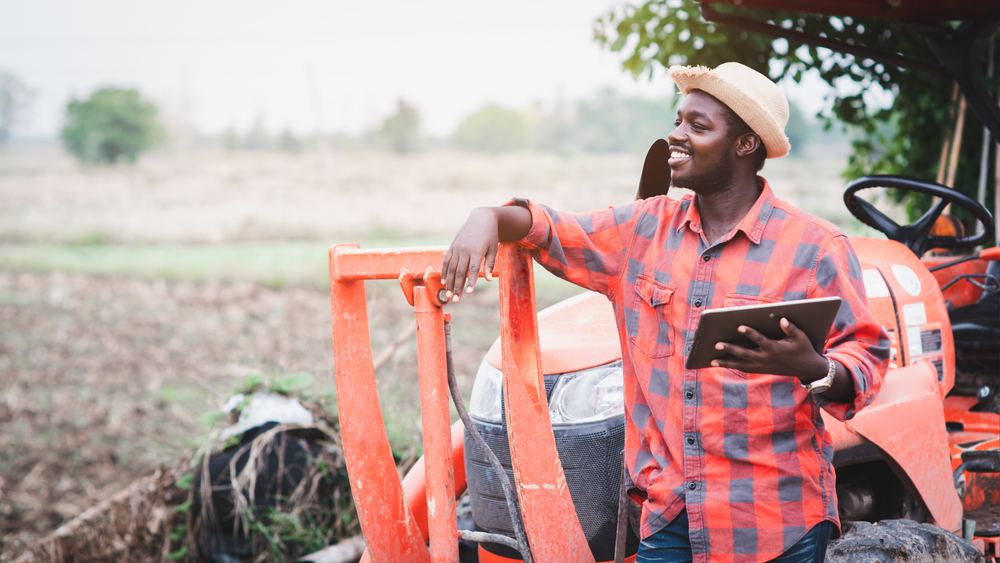African,Man,Farmer,Working,In,The,Field,With,A,Tractor